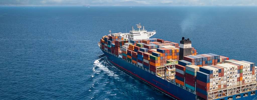 Large container ship sailing on open ocean