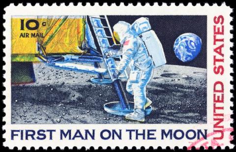 US 10-cent air mail postage stamp "First Man on the Moon" showing astronaut descending lunar module ladder