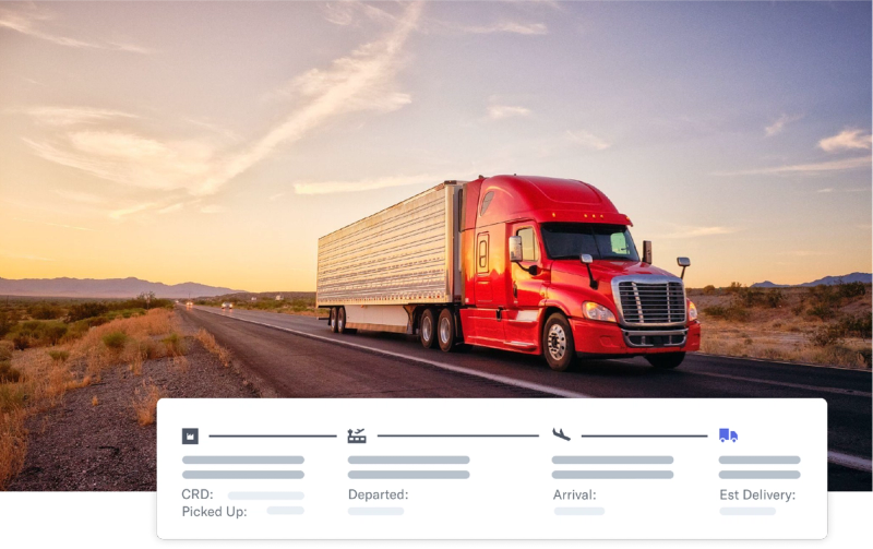 Red semi truck on a desert highway at sunset with a Flexport shipment-milestone tracking card overlaid
