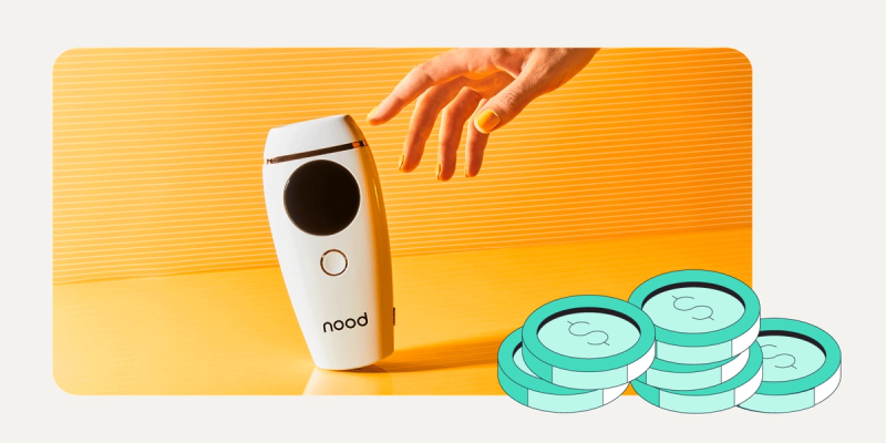 Nood at-home laser hair removal device on an orange background with a reaching hand and stacks of coins illustration