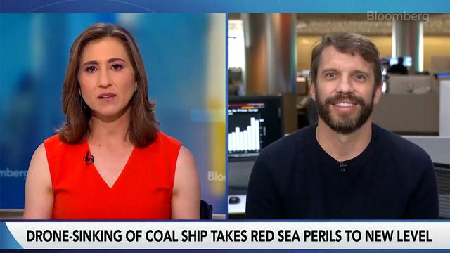Bloomberg TV split-screen interview: anchor on left, bearded guest on remote video feed on right, with lower-third headline on Red Sea ship attack