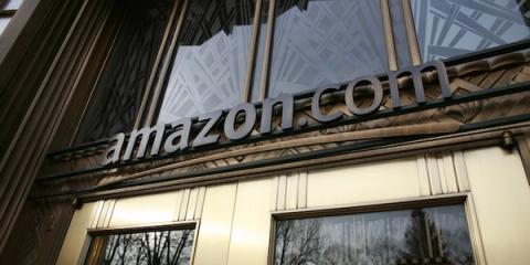 Amazon.com wordmark sign mounted on the exterior of a building, viewed from below