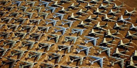 Aerial view of rows of stored aircraft parked in a desert boneyard