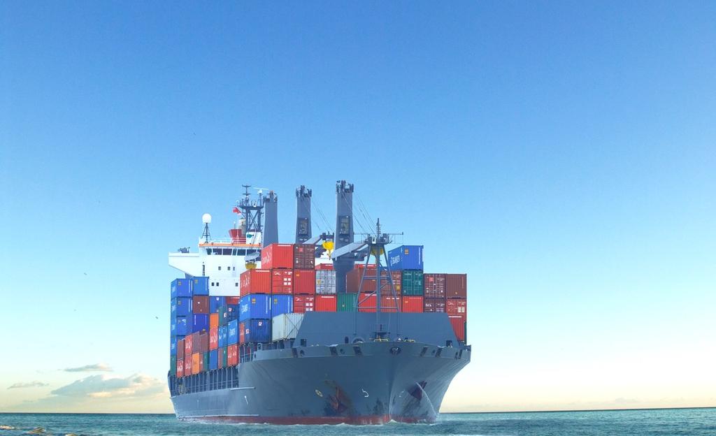 Large cargo ship transporting shipping containers across the ocean.
