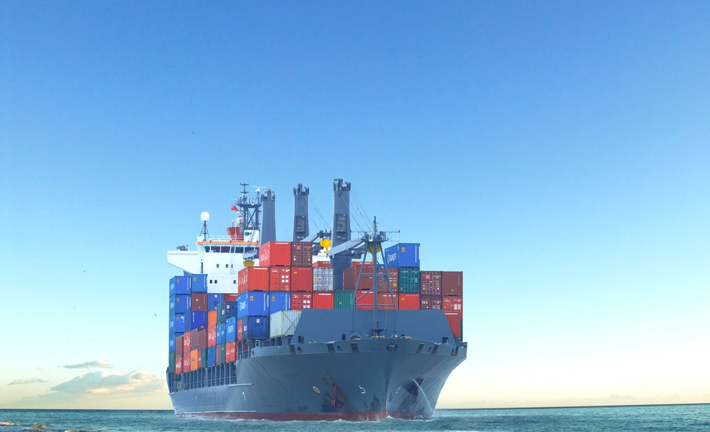 Large cargo ship transporting shipping containers across the ocean.