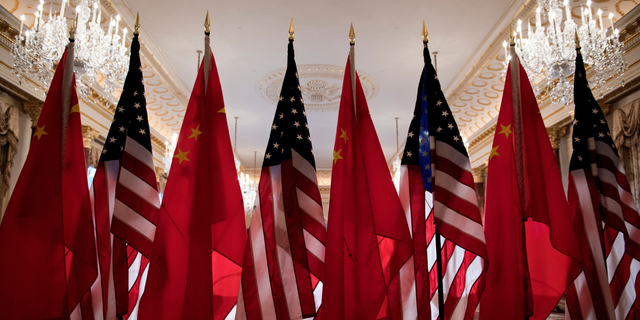 Rows of Chinese and American flags displayed side by side, evoking the U.S.-China trade war
