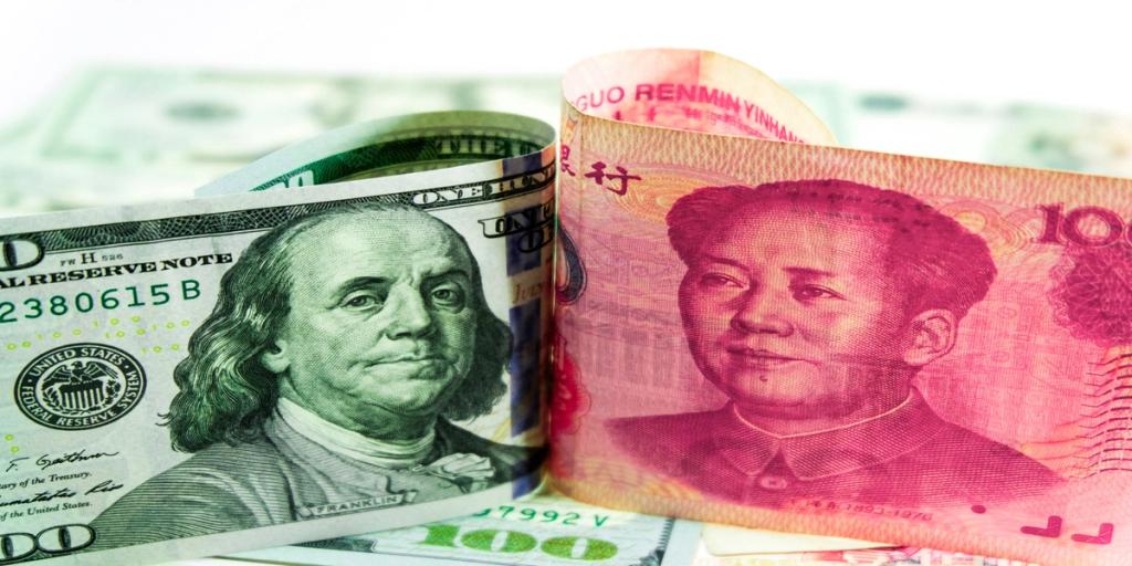 Folded U.S. one-hundred-dollar bill beside a Chinese 100-yuan note showing Franklin and Mao portraits