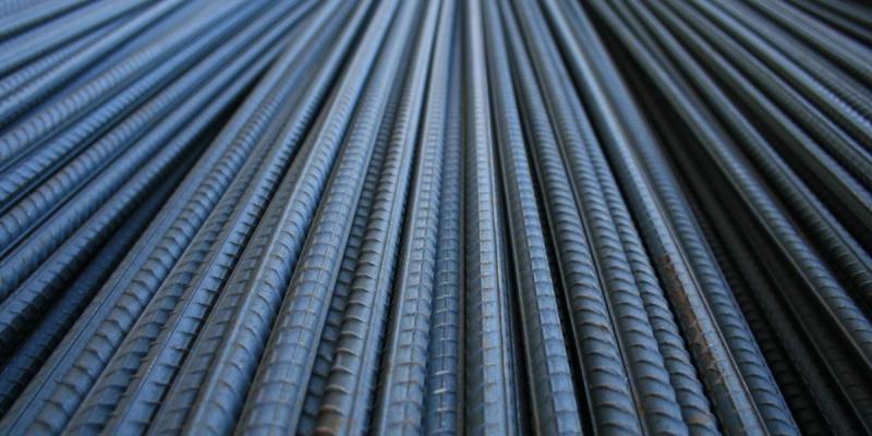 Close-up of bundled ribbed steel rebar bars receding in parallel lines