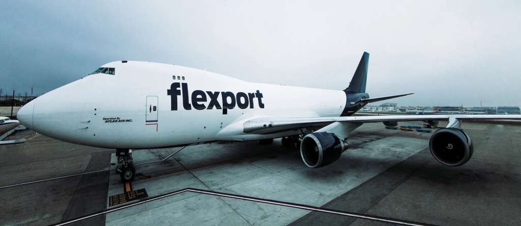 Flexport-branded Boeing 747 cargo freighter parked on an airport tarmac under an overcast sky