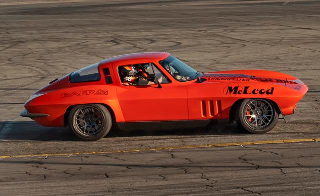 Orange Chevrolet Corvette race car with McLeod and Lingenfelter decals driving on a track