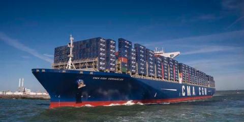 Blue CMA CGM Kerguelen container ship fully loaded with containers sailing under a clear sky