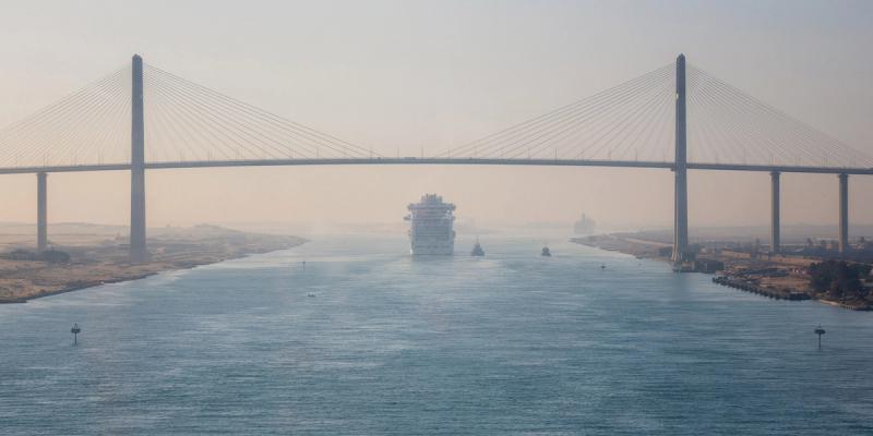 Container ship transiting the Suez Canal under the cable-stayed Suez Canal Bridge in haze