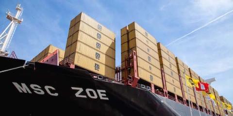 Container ship MSC ZOE loaded with stacked containers under a blue sky