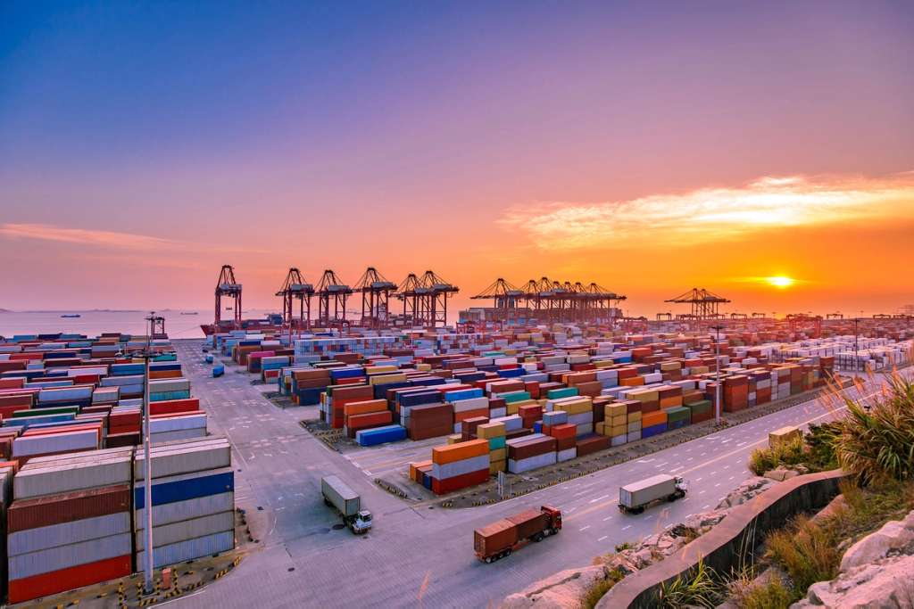 Ocean port at sunset with thousands of containers