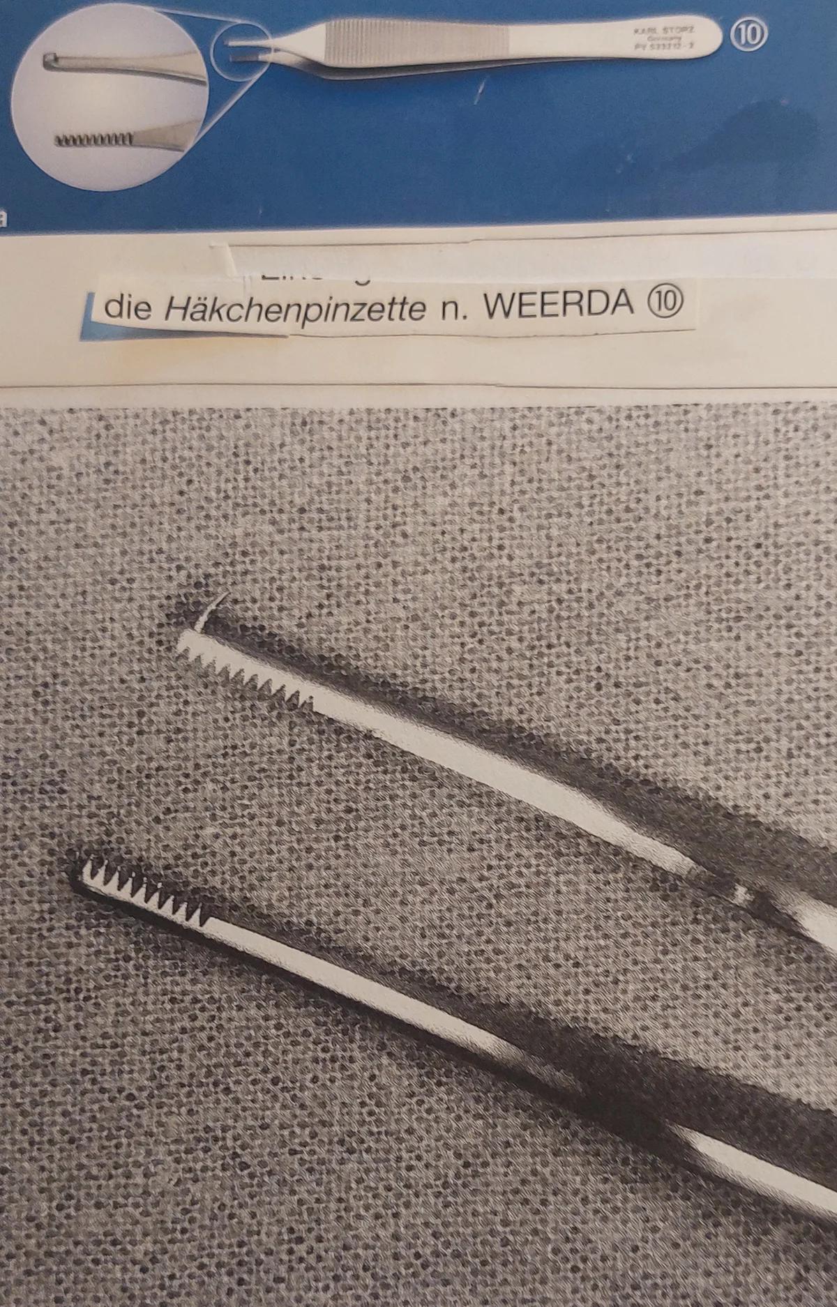 Hooked forceps with an enlarged view of the tip.