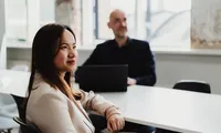 HR professional reviewing a digital background check report on a tablet with global data visualization.