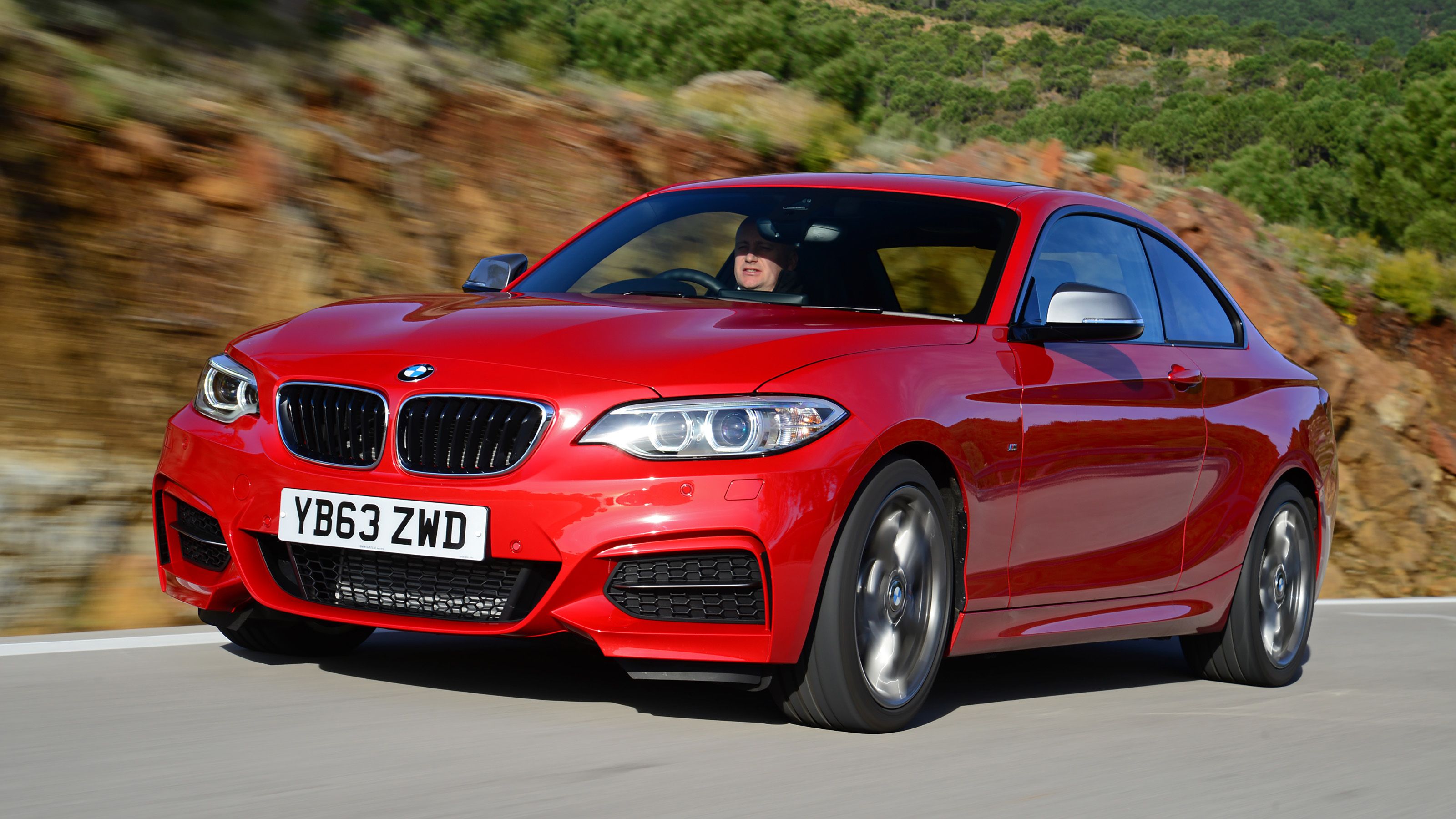 Red BMW M235i front driving