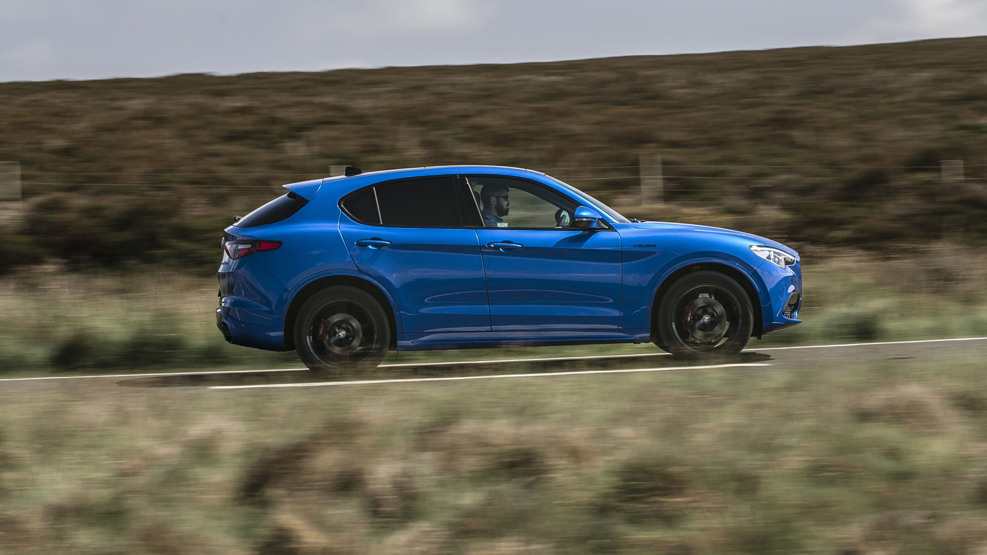 Blue Alfa Romeo Stelvio side driving