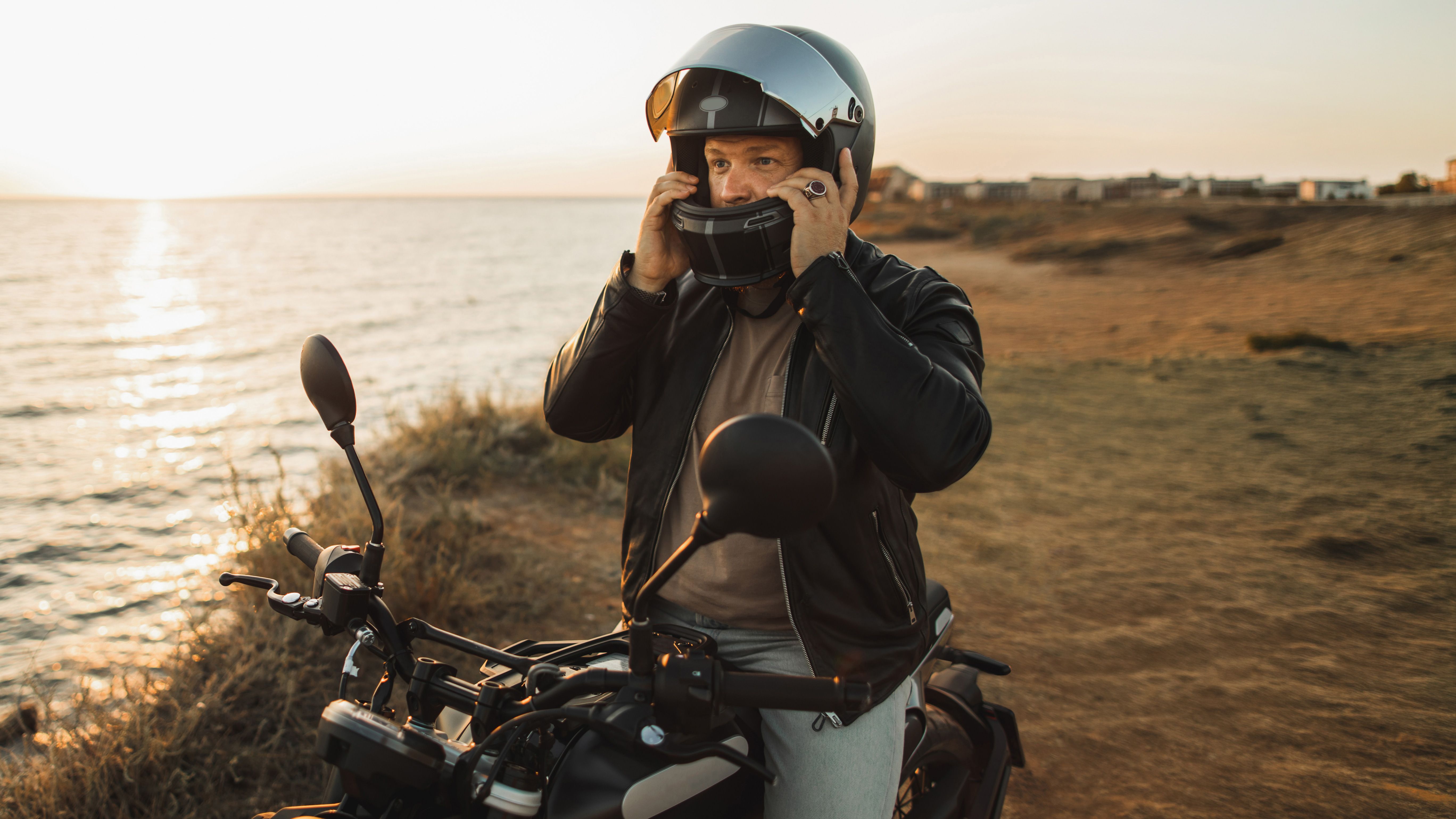 Man putting on his motorbike helmet