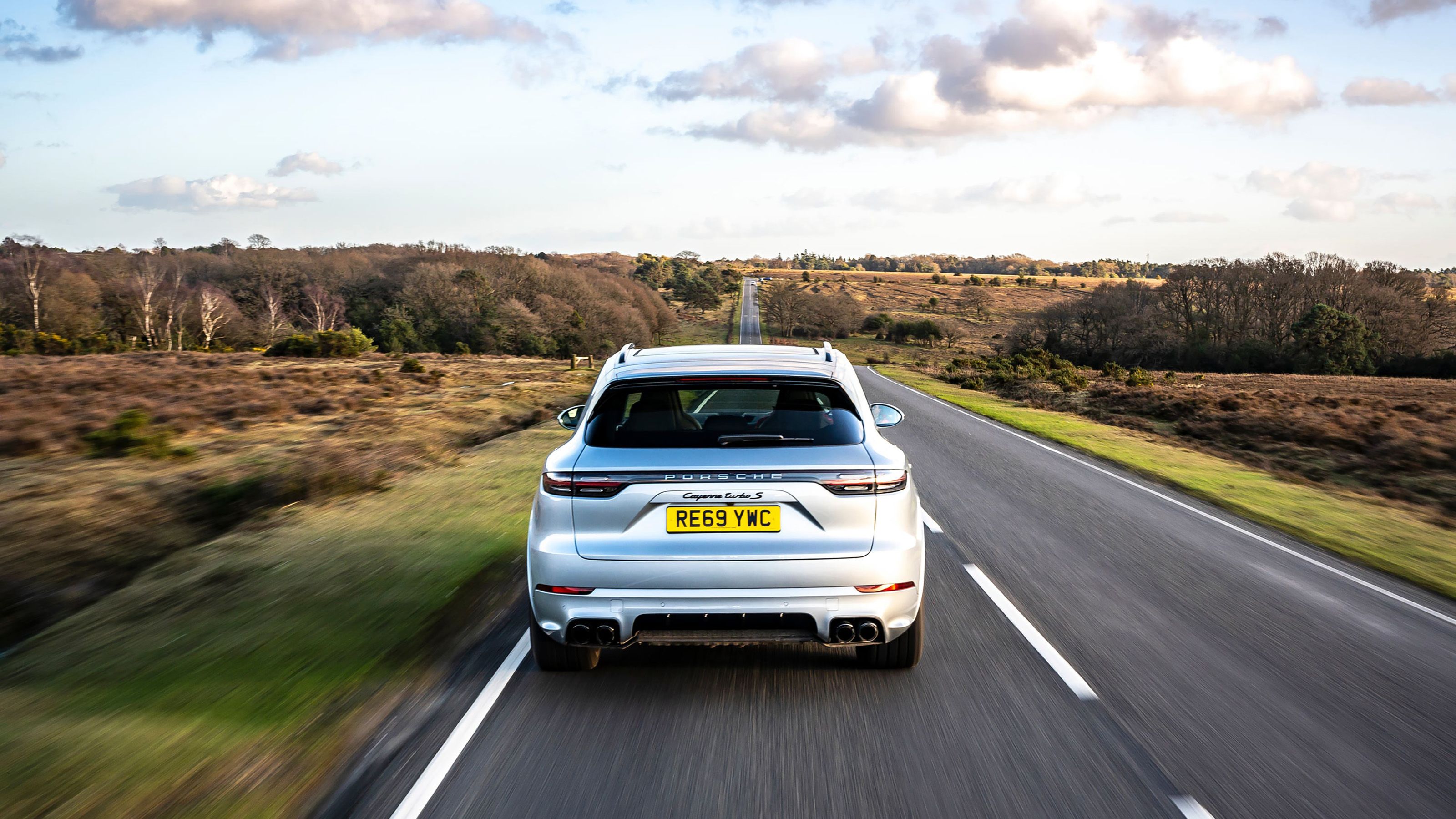 Silver Porsche Cayenne rear driving