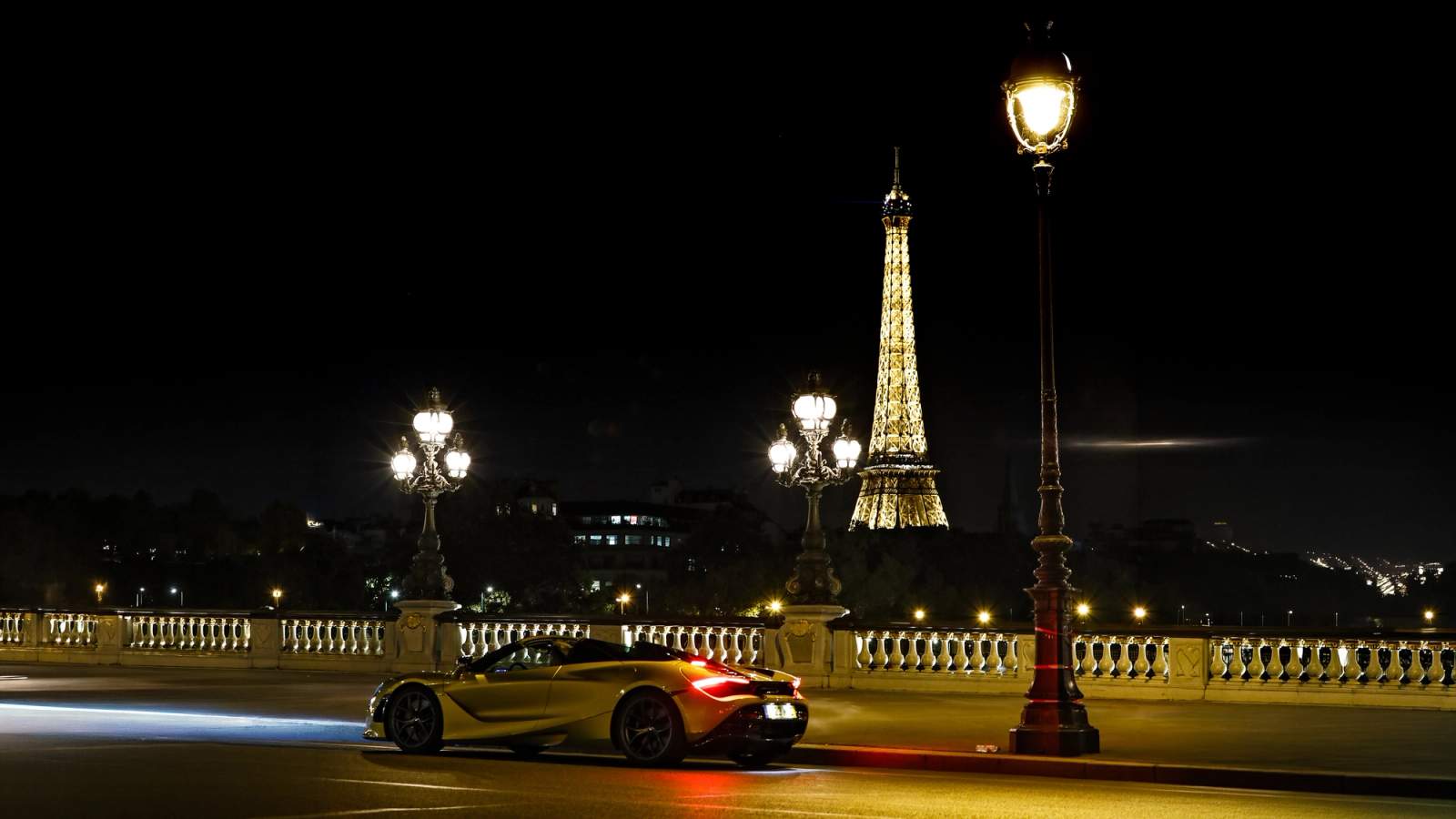 Car driving next to the Eiffel Tower