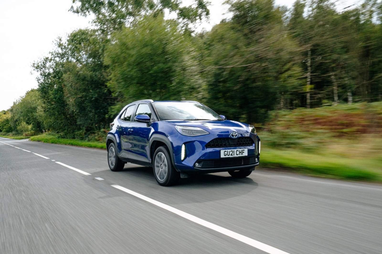 Blue Toyota Yaris Cross driving