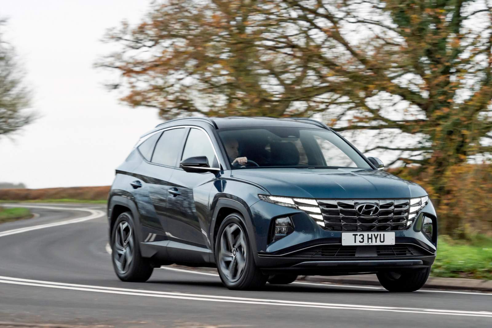 Grey Hyundai Tucson driving