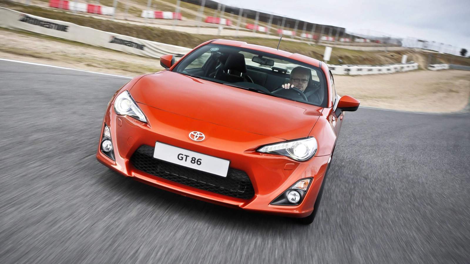Orange Toyota GT86 driving on track