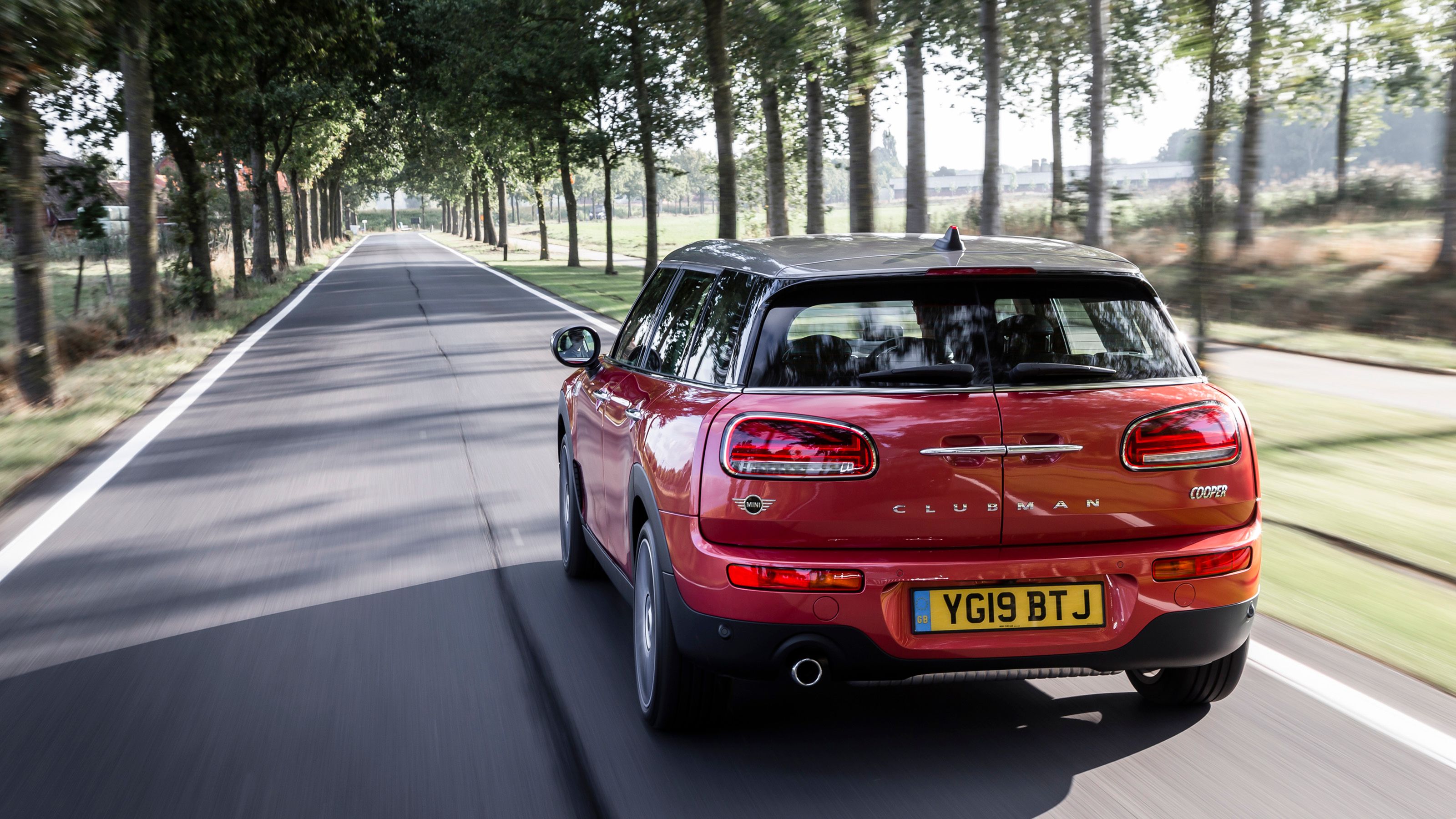 Red Mini Clubman rear driving
