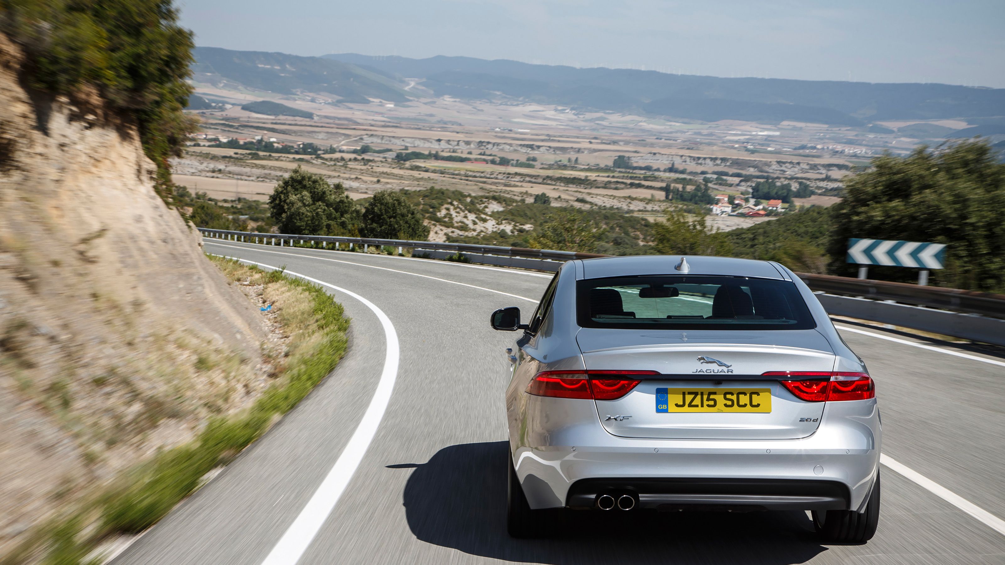 Silver Jaguar XF rear driving