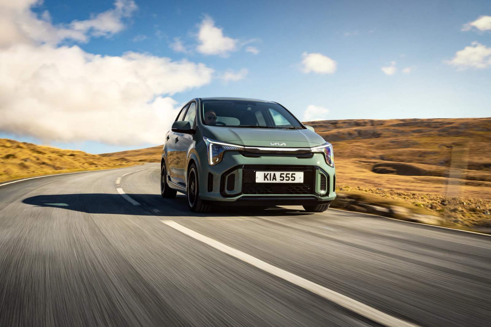 Green Kia Picanto driving