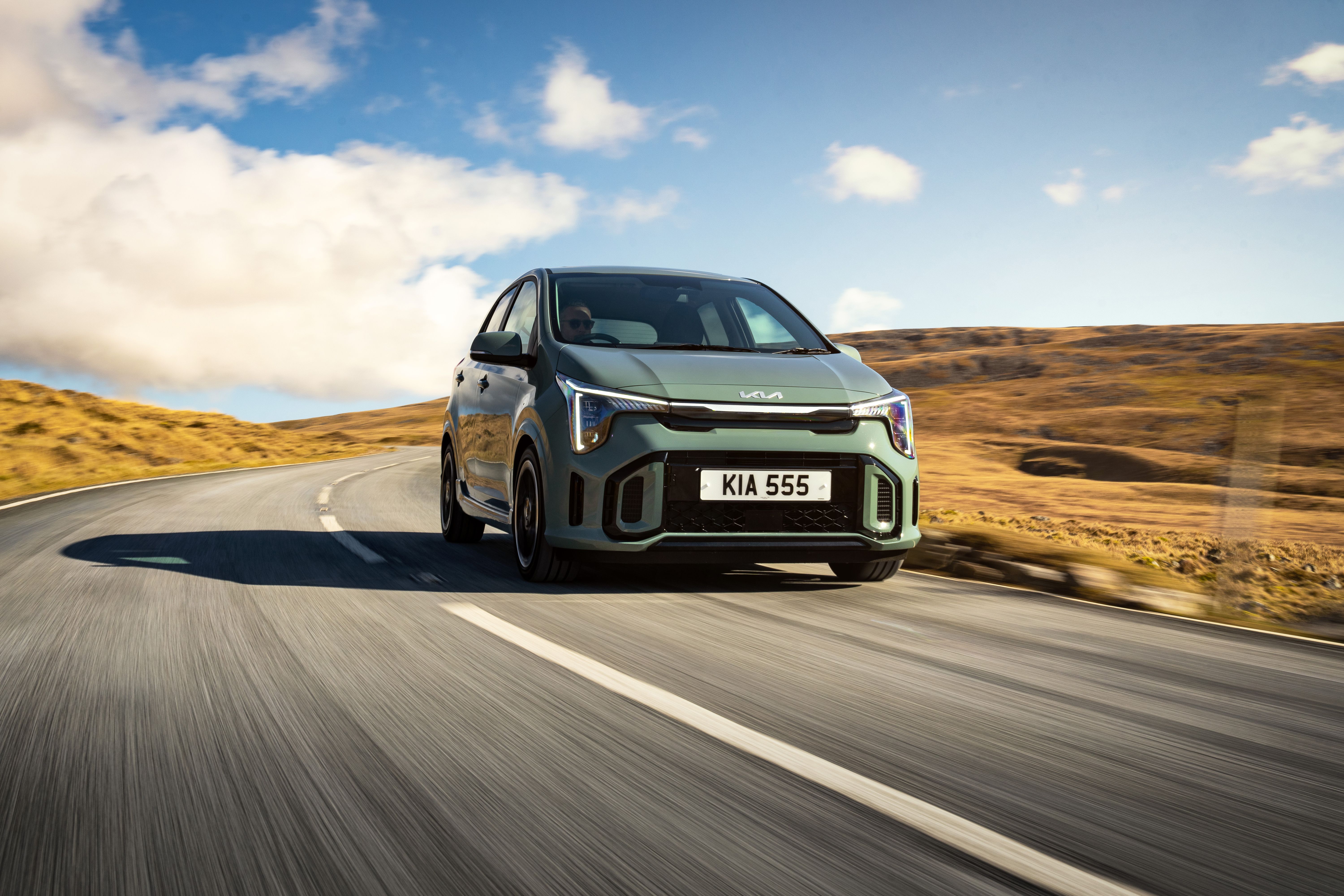 Green Kia Picanto driving