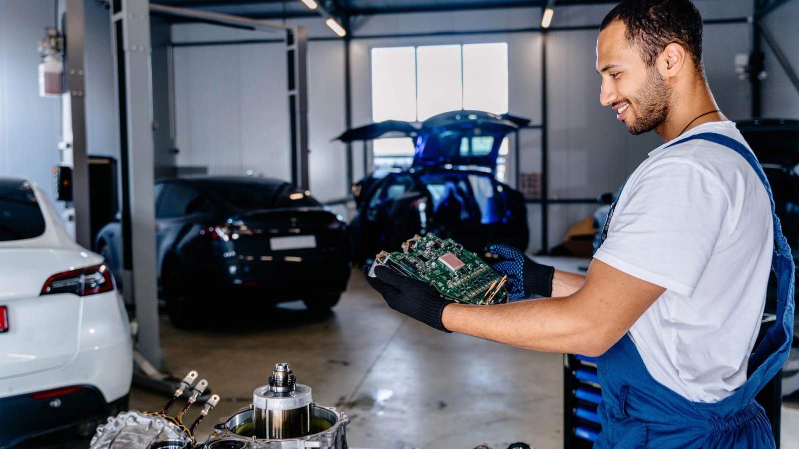 EV technician inspecting a component