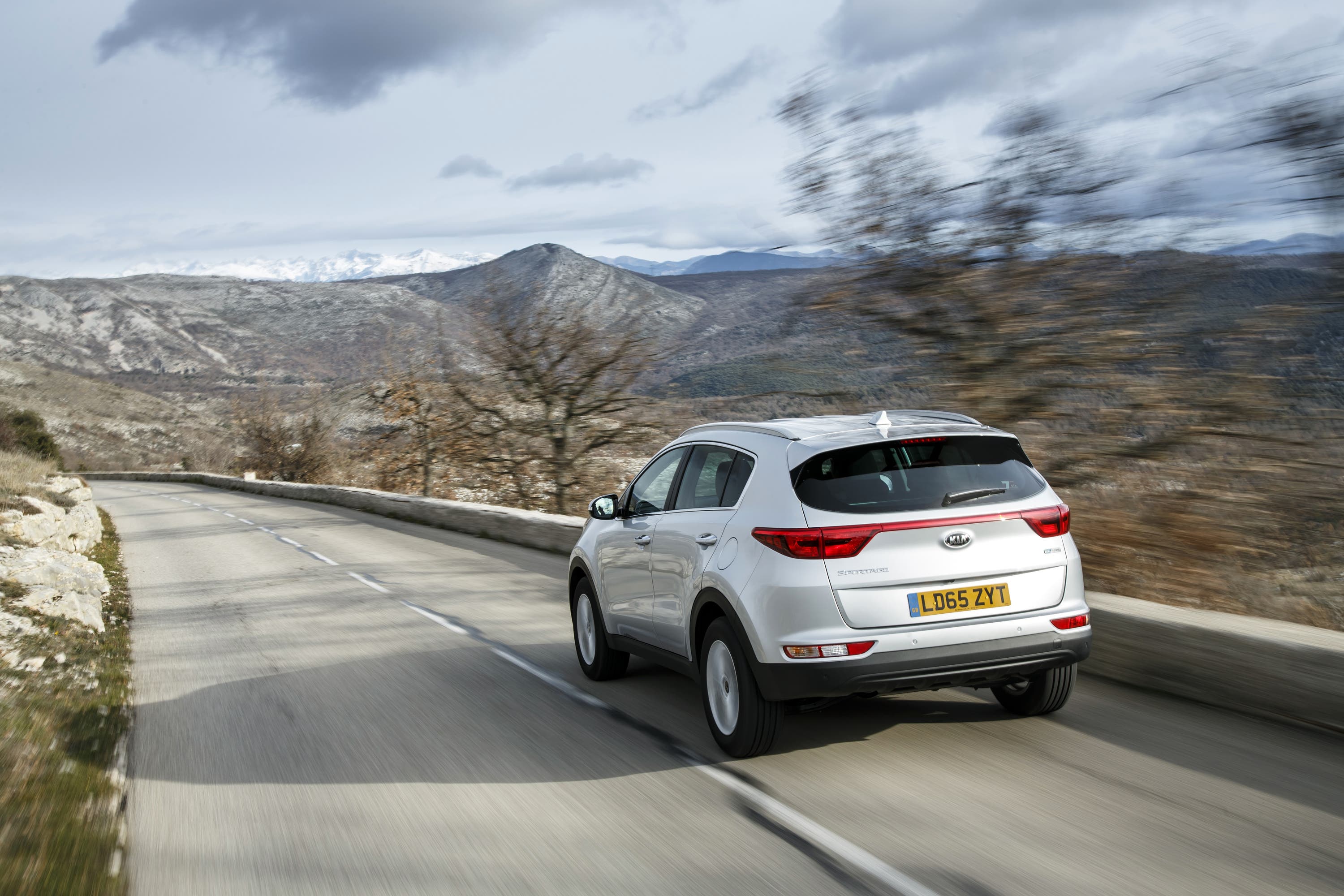 Silver Kia Sportage driving