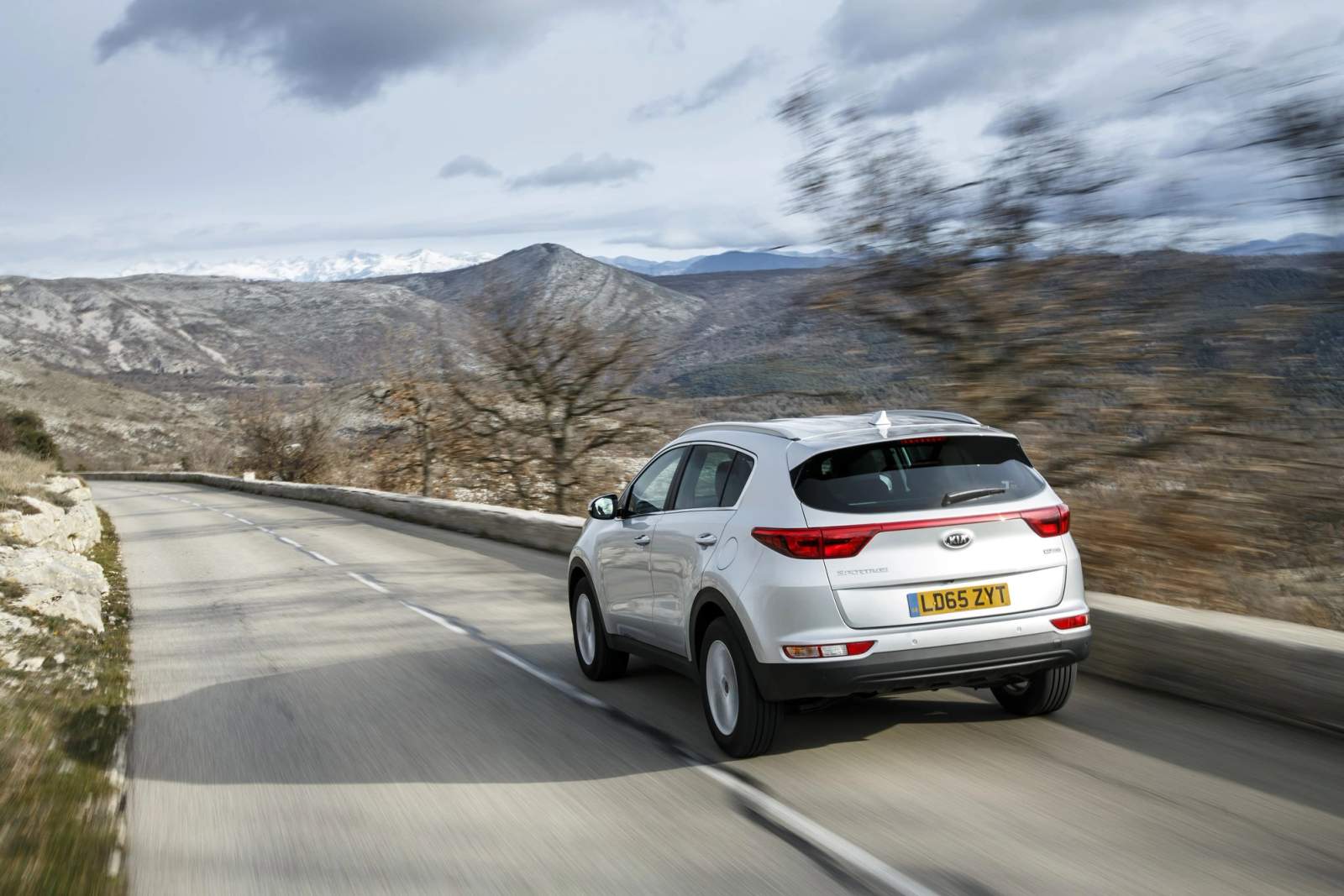Silver Kia Sportage driving
