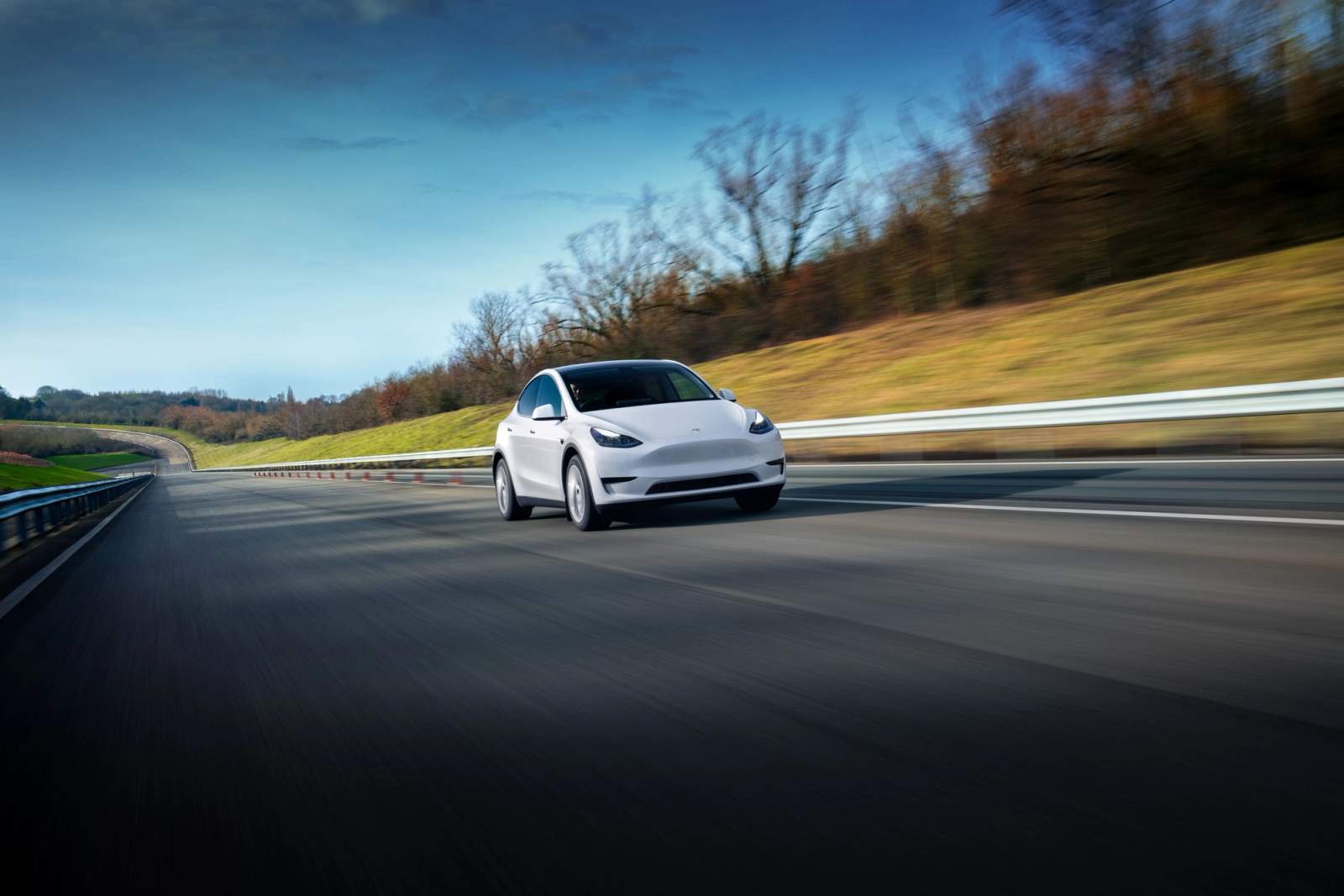 White Tesla Model Y driving