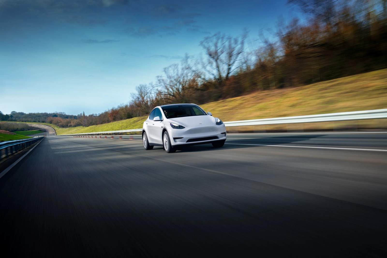 White Tesla Model Y driving