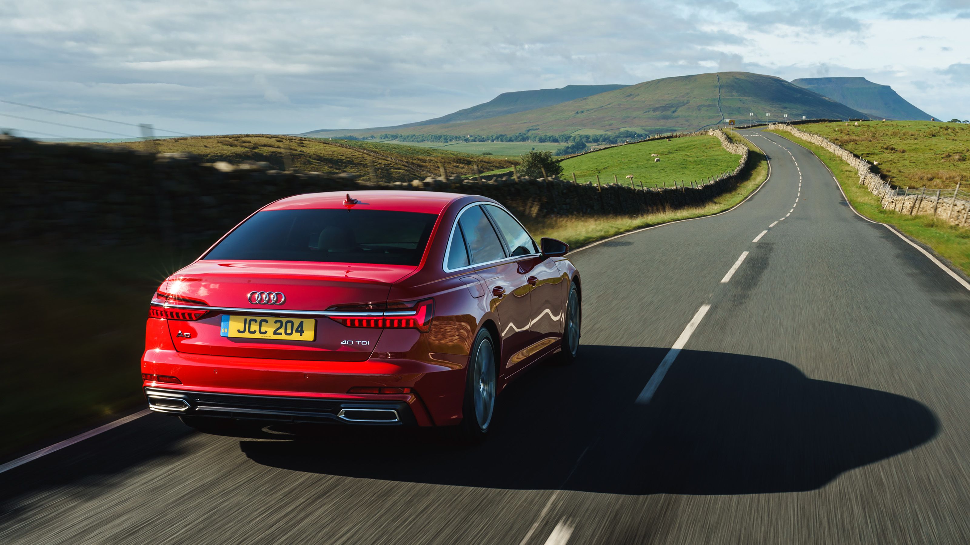 Red Audi A6 rear driving
