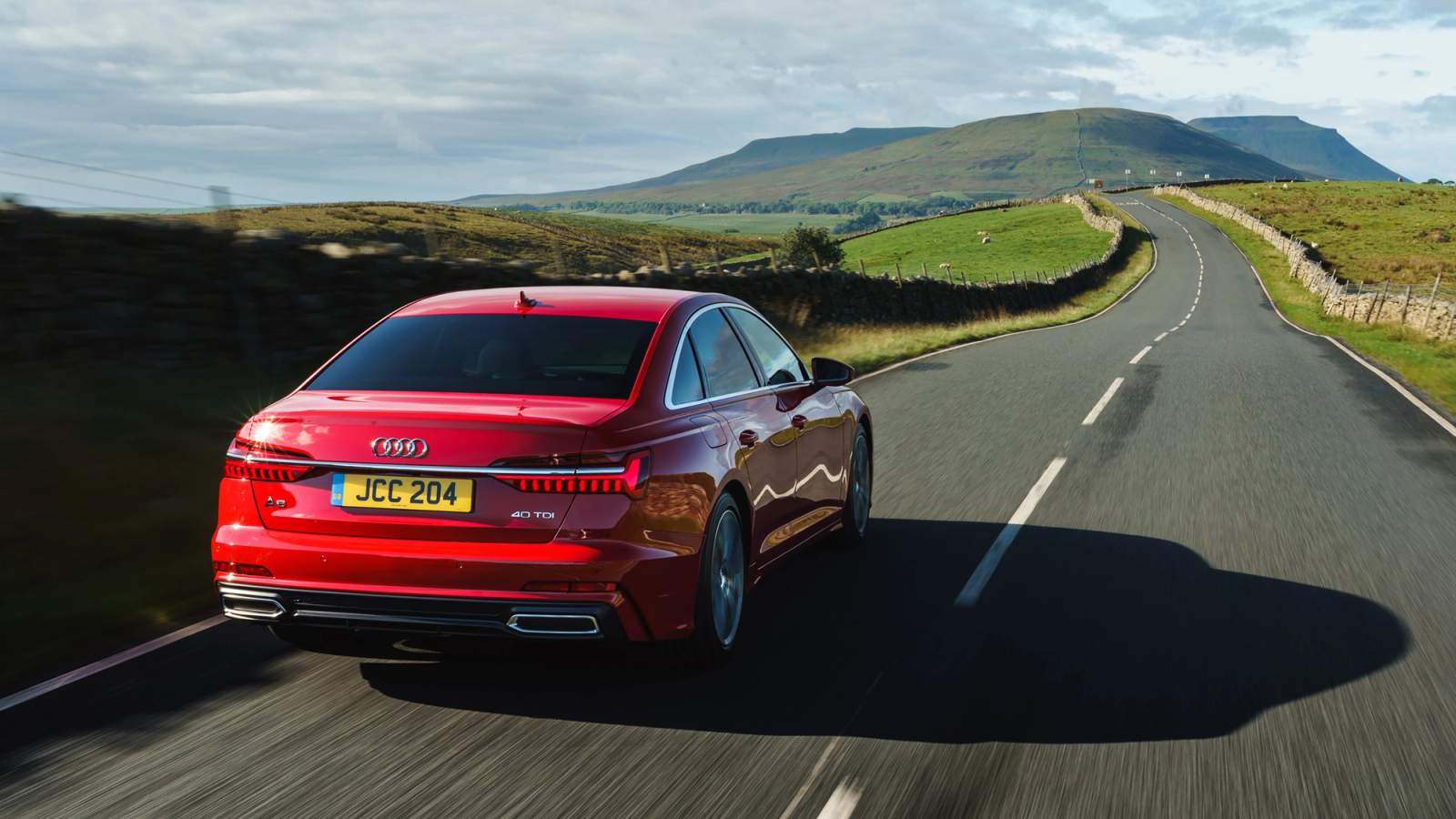 Red Audi A6 rear driving