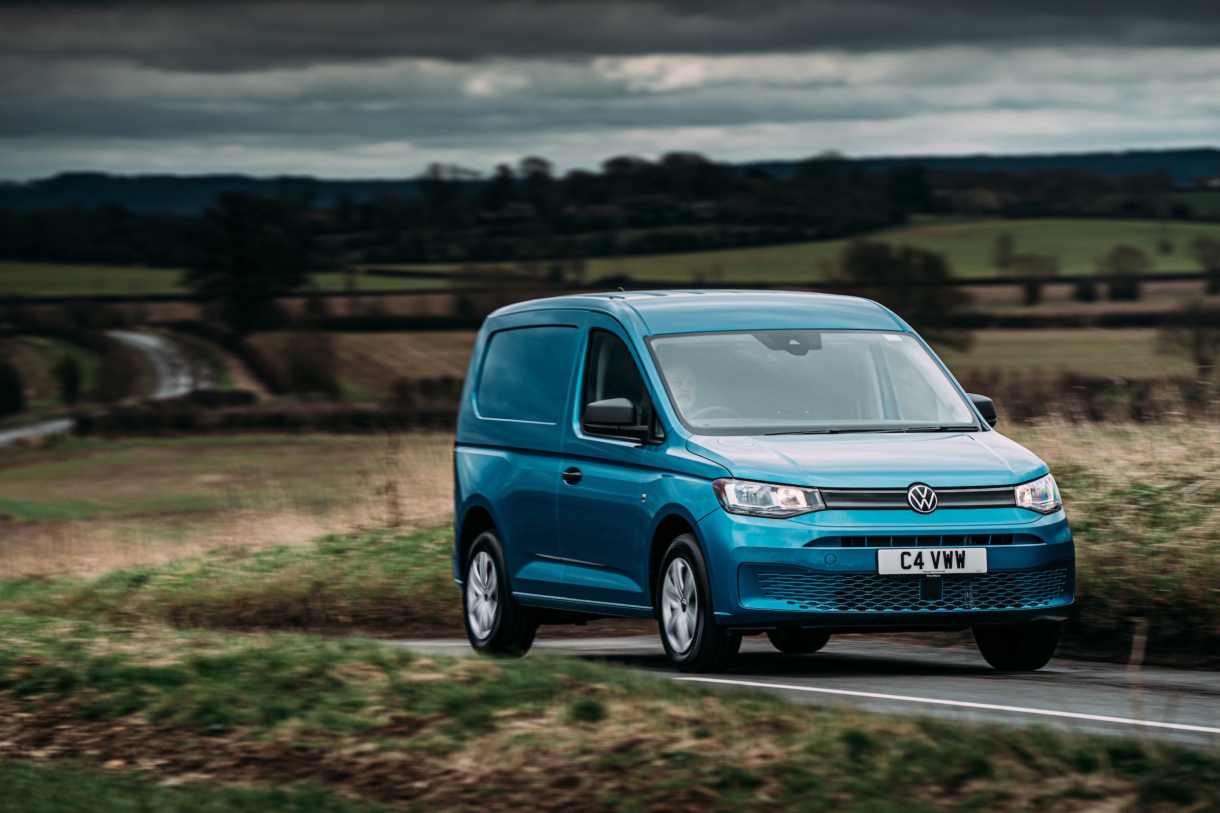 Blue Volkswagen Caddy Cargo driving
