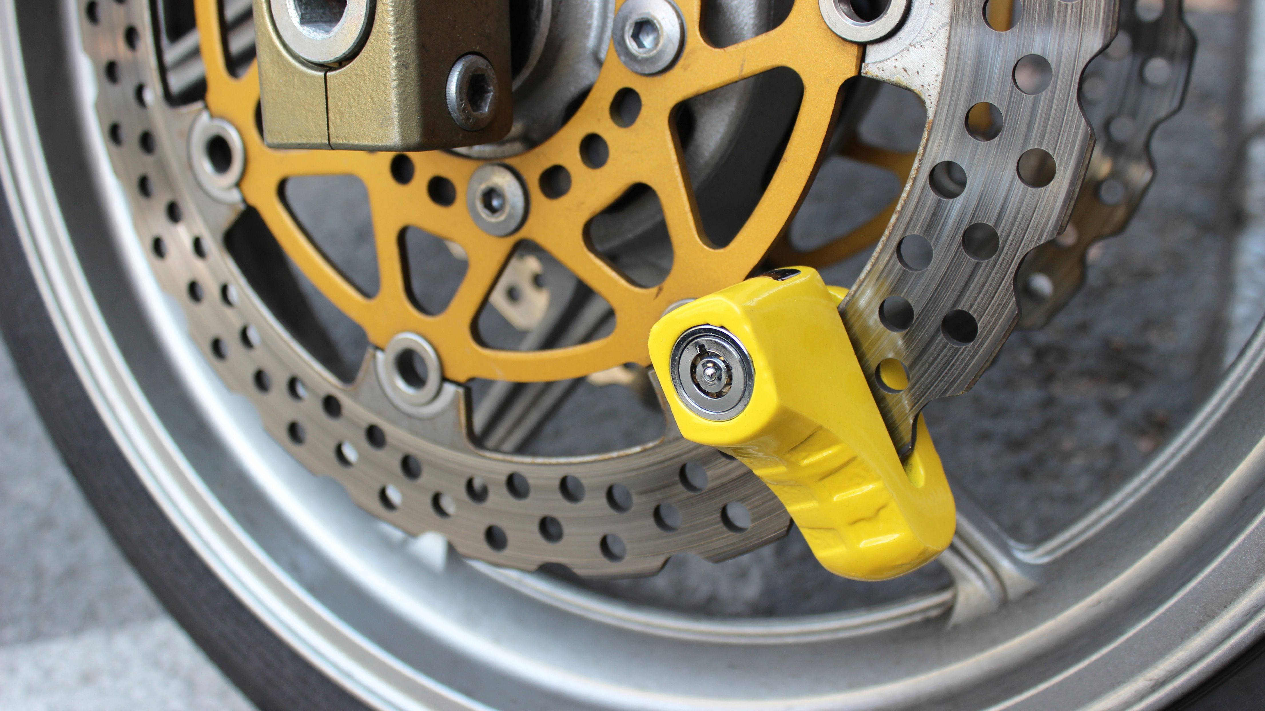 Yellow disc lock on motorbike wheel