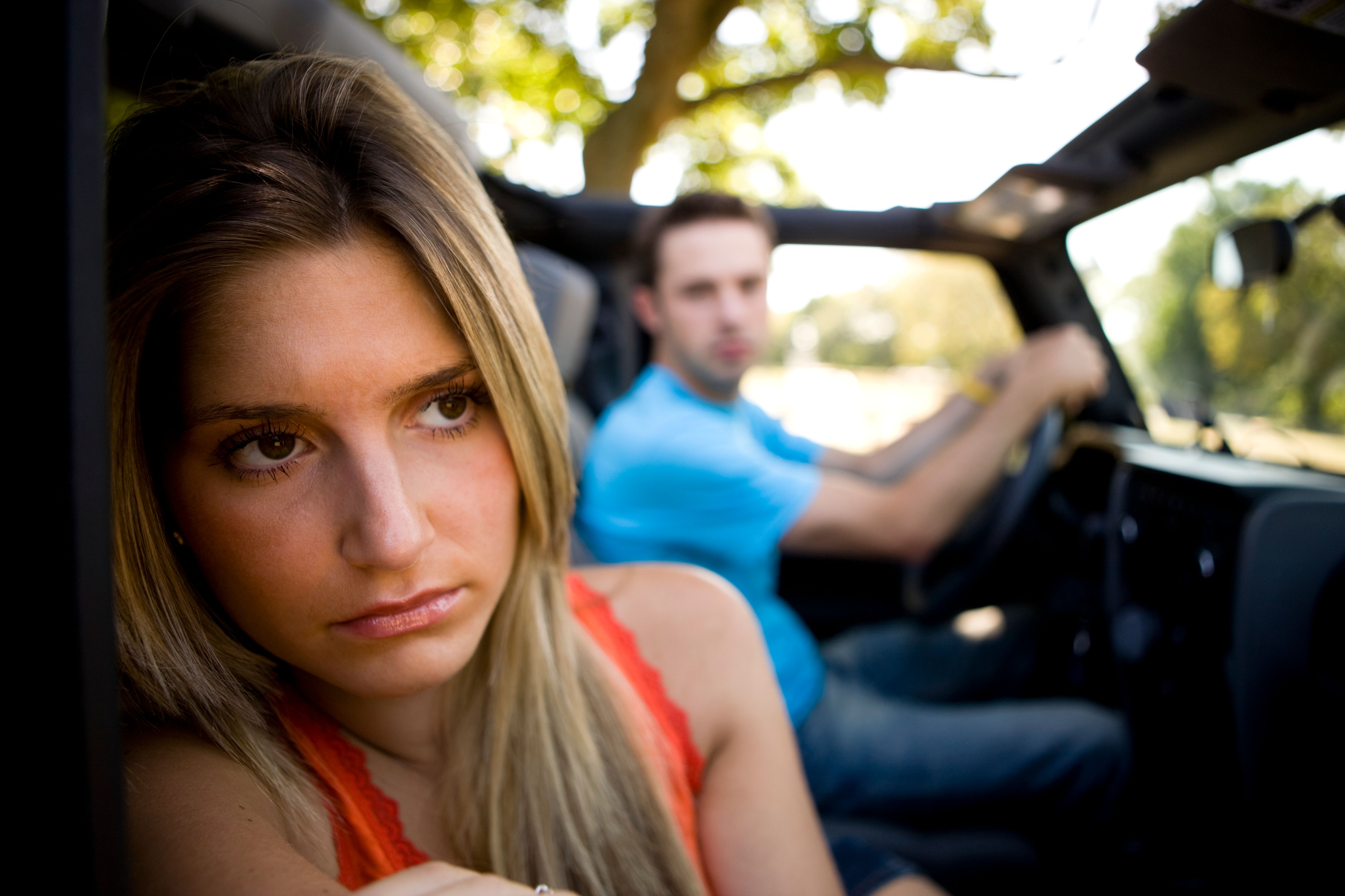 Couple looking fed up in a car