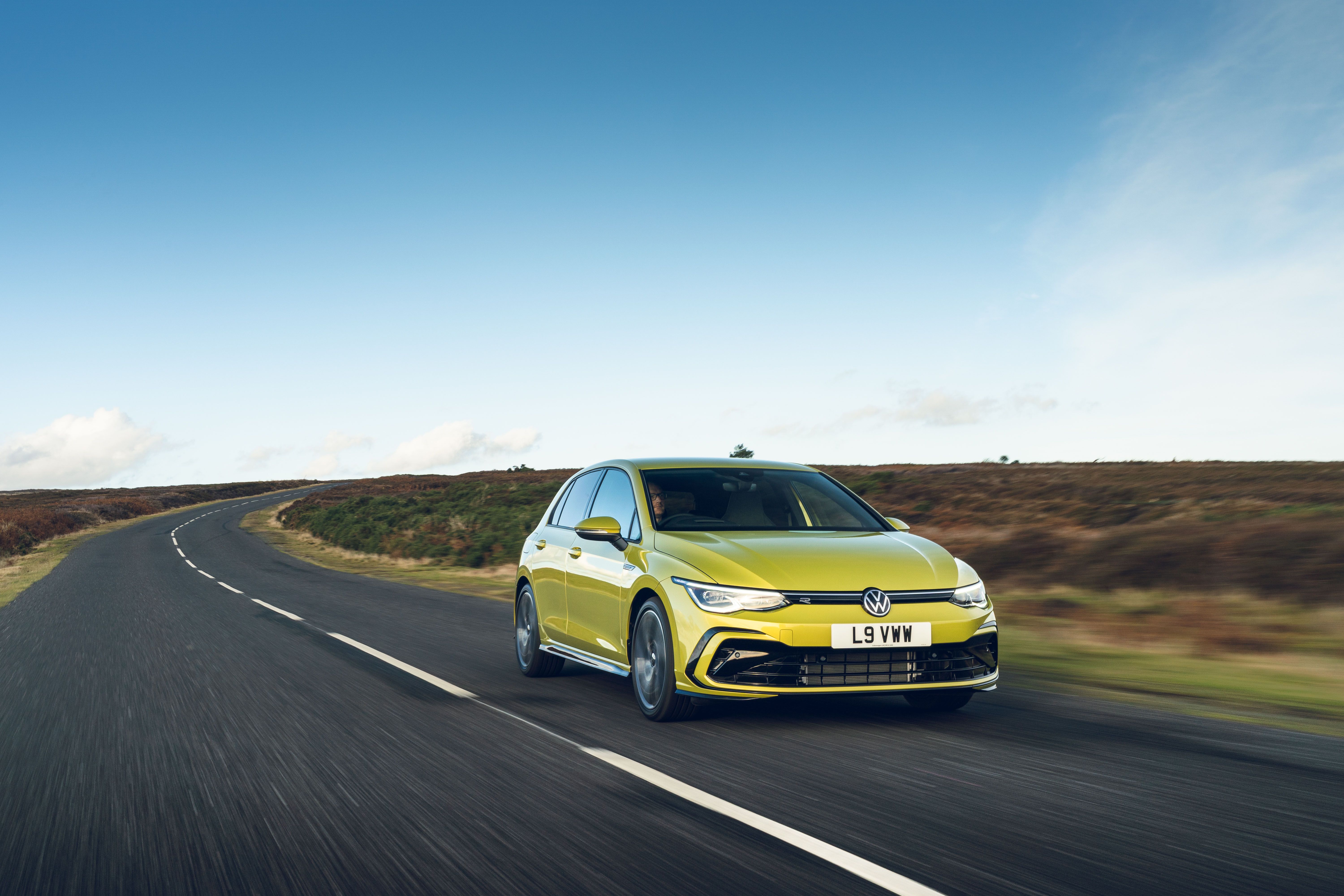 Yellow Volkswagen Golf driving
