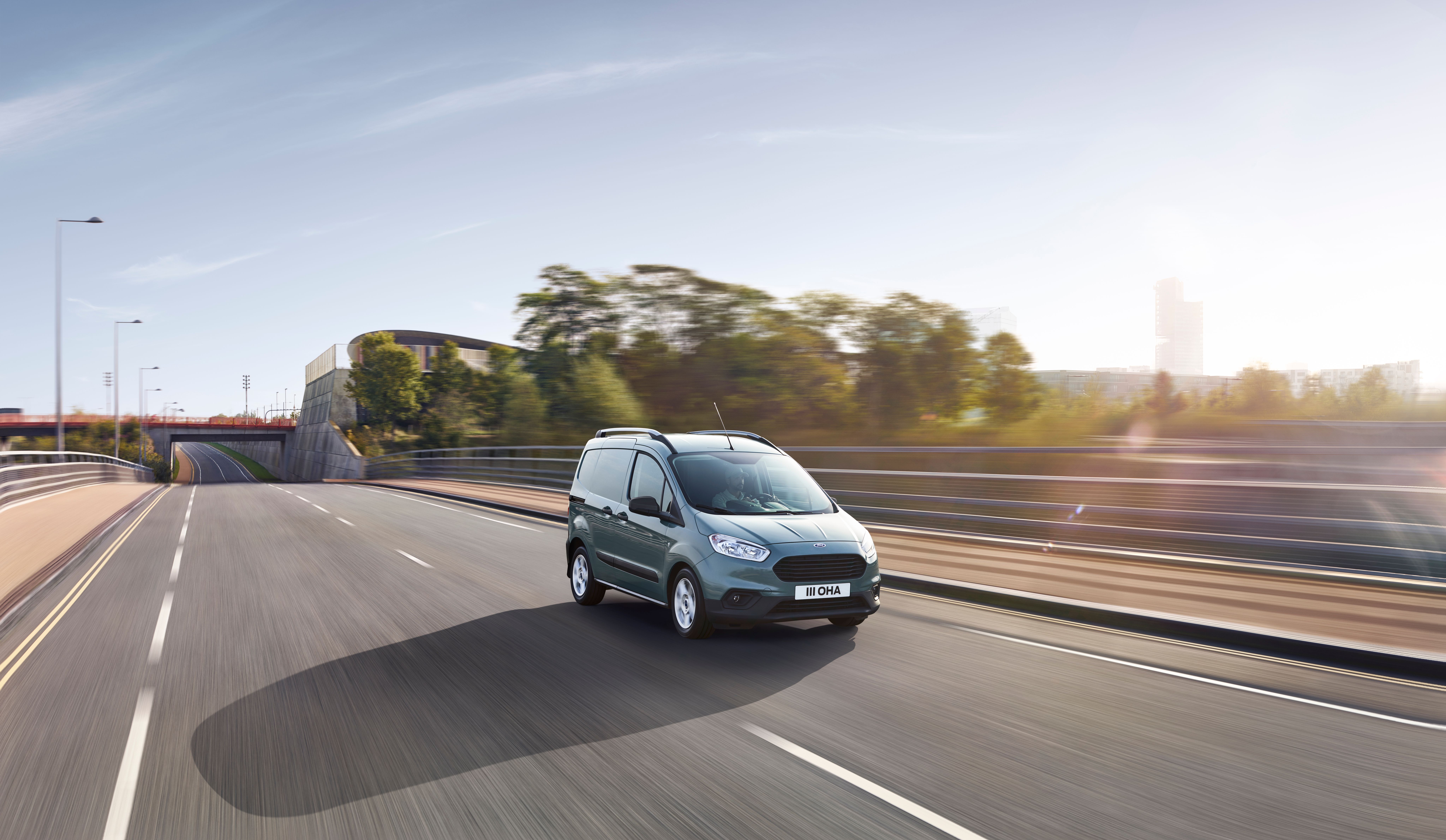 Blue Ford Transit Courier driving