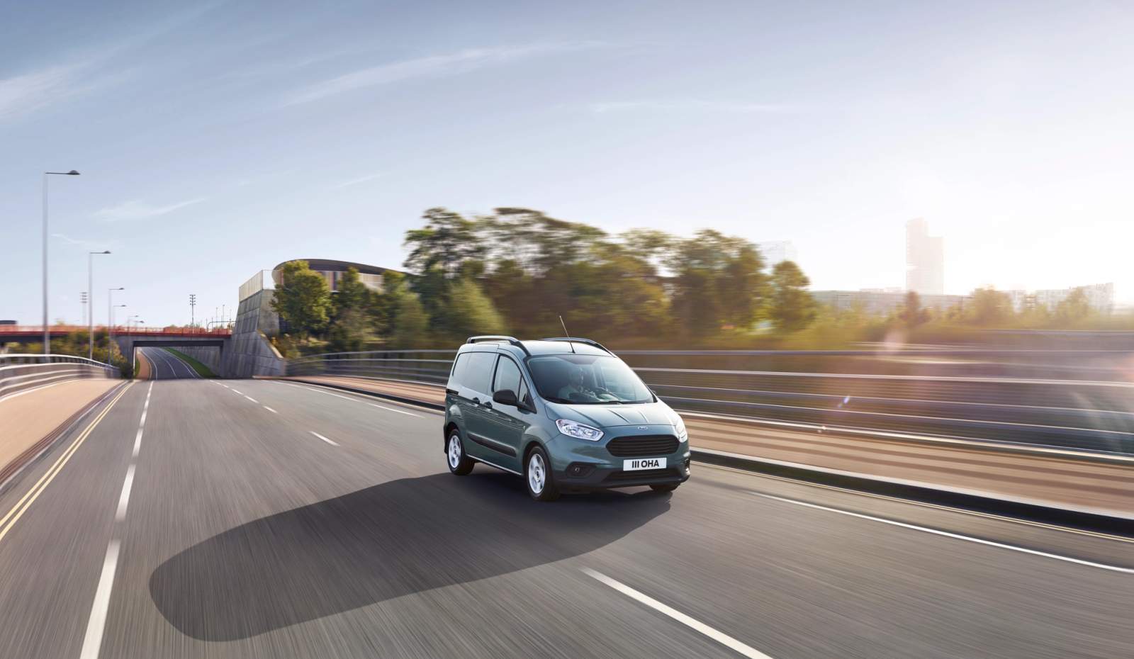 Blue Ford Transit Courier driving