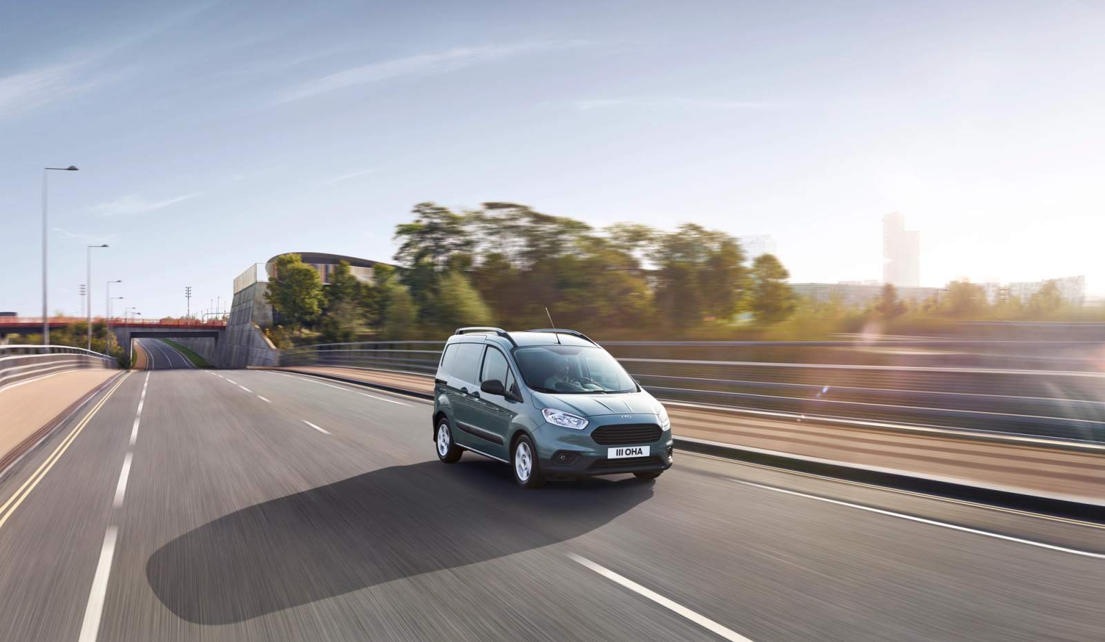 Blue Ford Transit Courier driving