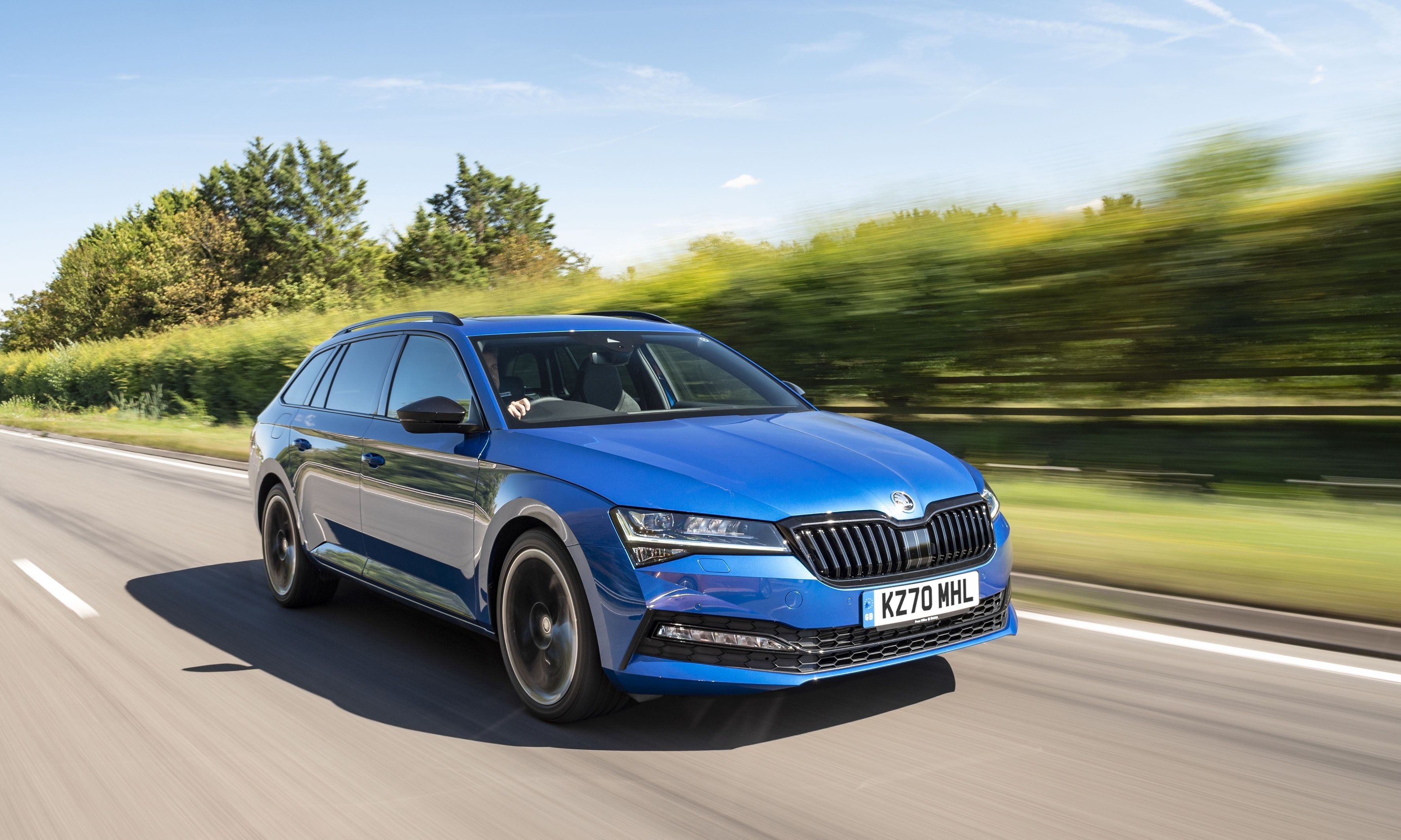 Blue Skoda Superb Estate driving