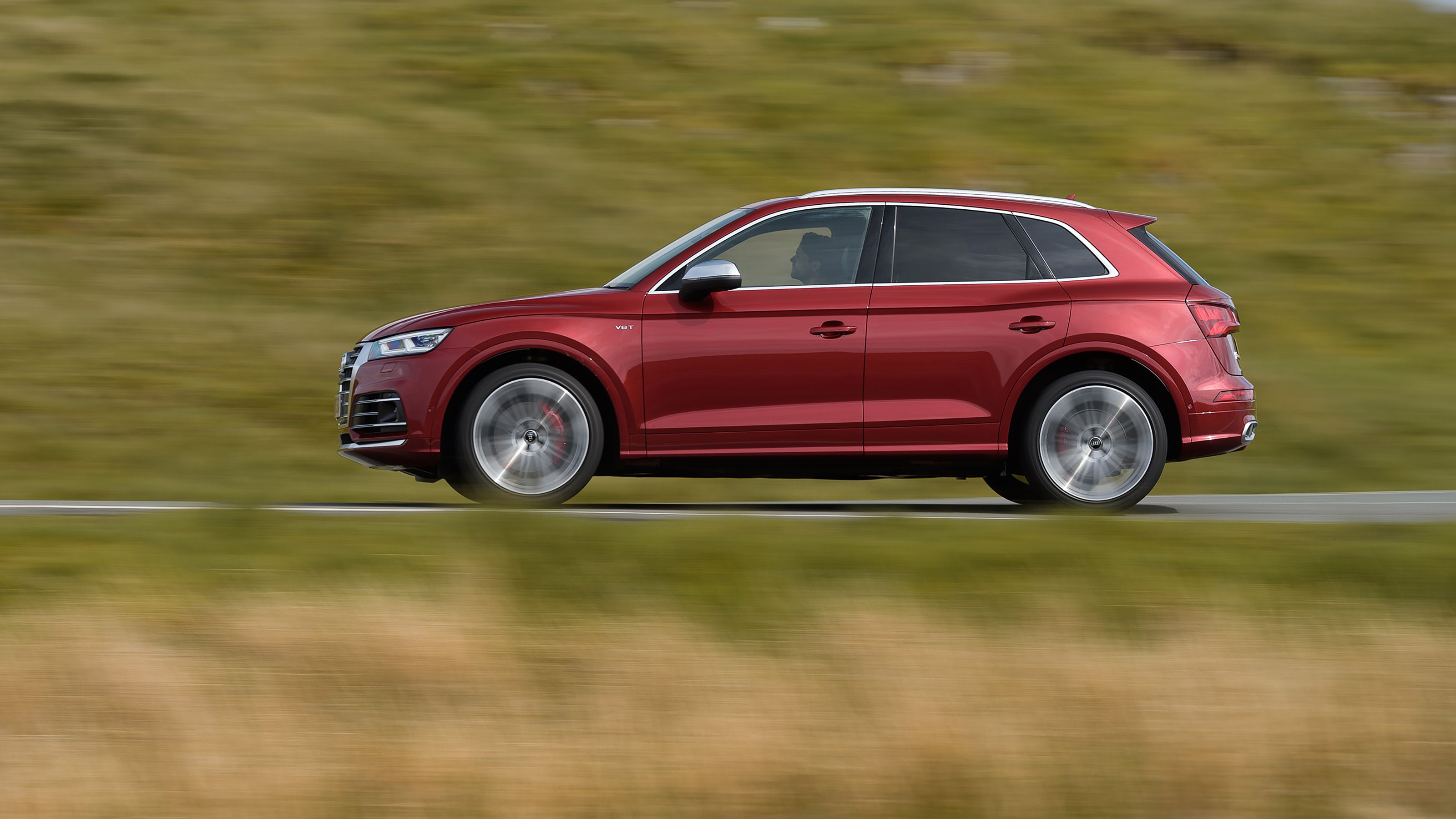 Red Audi SQ5 side driving