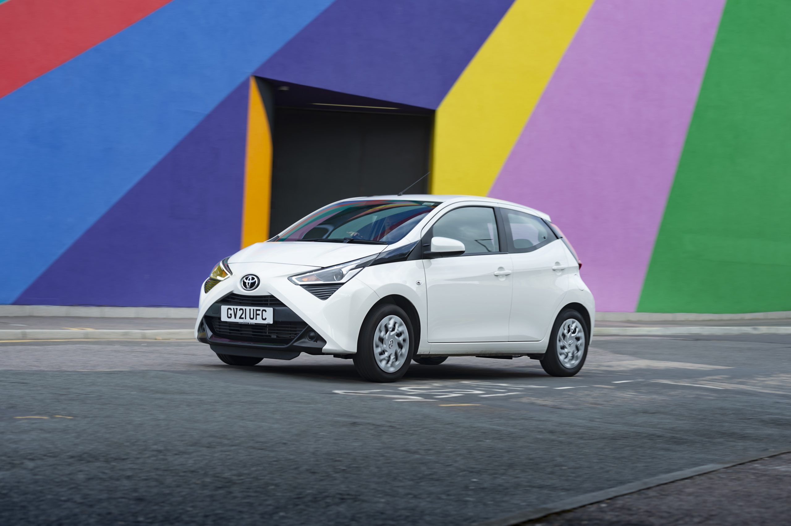 White Toyota Aygo driving