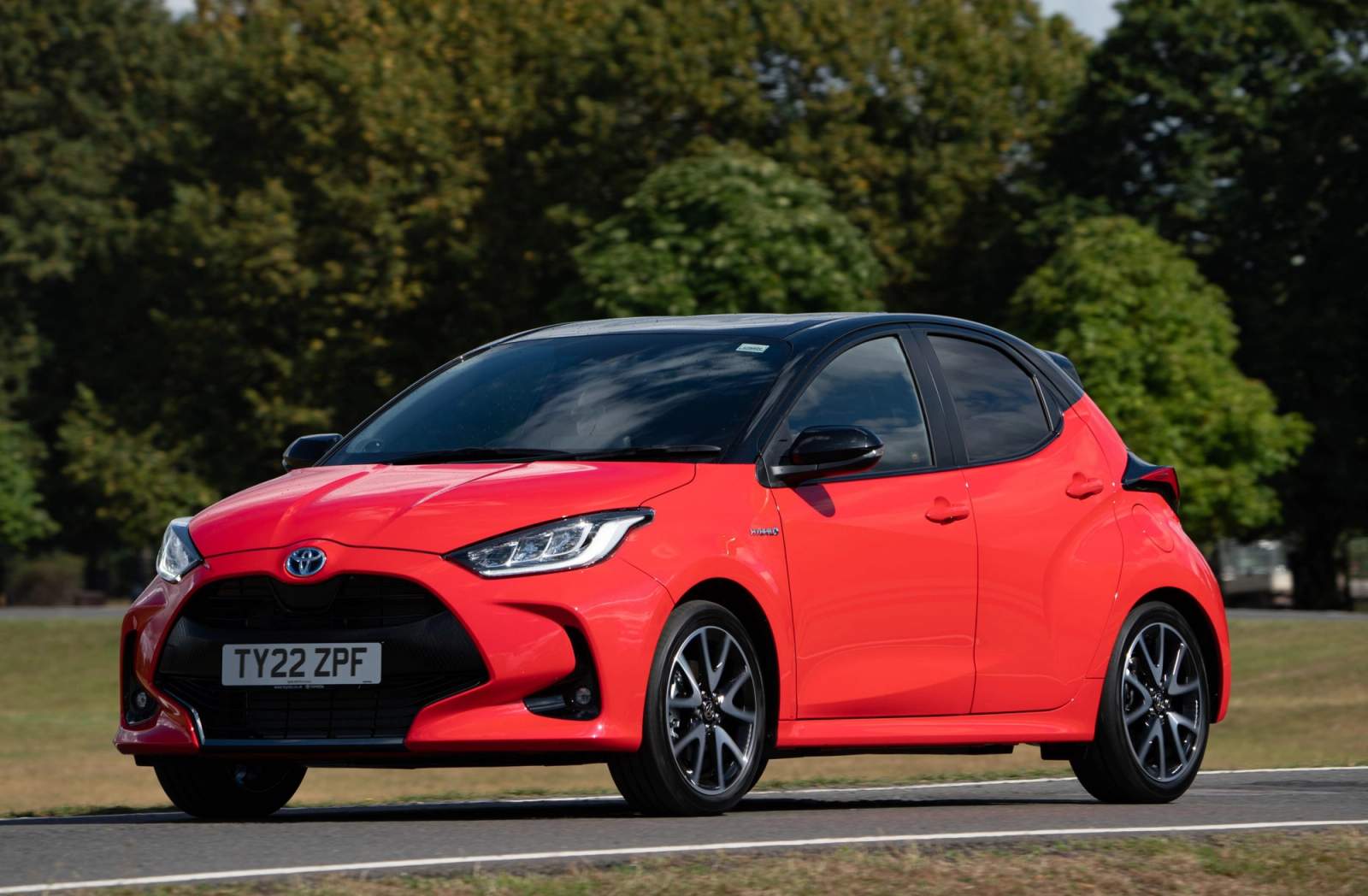 Red Toyota Yaris driving